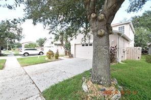 A two-story house with a concrete driveway and a large tree in the front yard — 504 MAPLE POINTE DRIVE, SEFFNER, FL