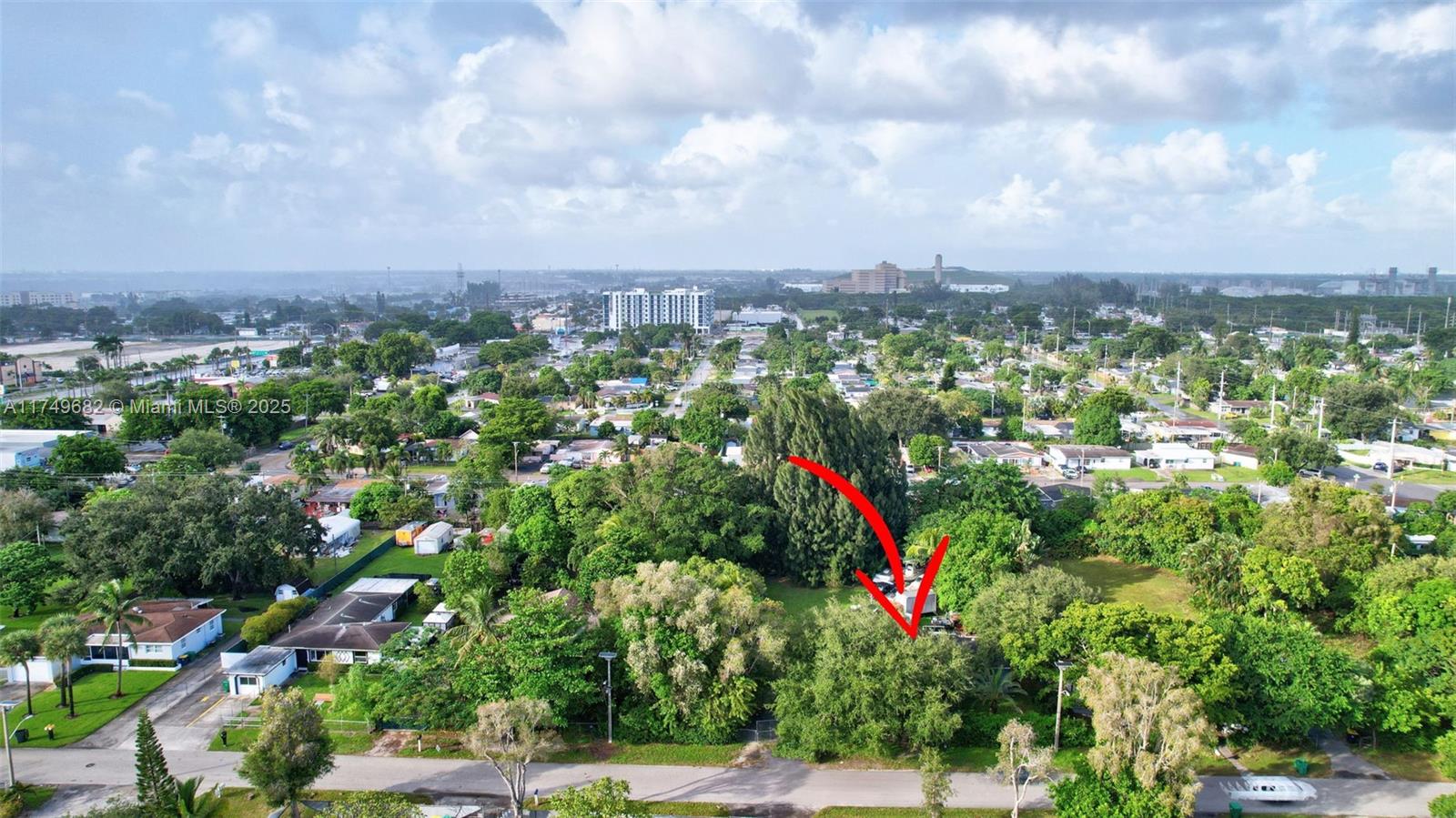 An aerial view shows a residential lot with dense trees and a small structure — 4381 SW 51st St, Dania Beach FL 33314, DANIA BEACH, FL