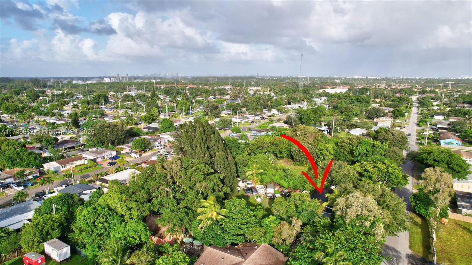 An aerial view shows a house partially obscured by dense trees and several parked vehicles — 4381 SW 51st St, Dania Beach FL 33314, DANIA BEACH, FL
