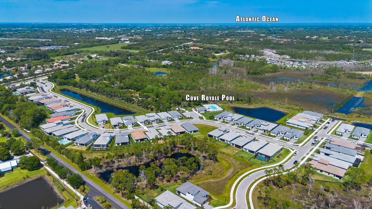 An aerial view shows a residential neighborhood with houses, a community pool, and surrounding greenery — 6980 SE Haven Lane, Stuart FL 34997, STUART, FL
