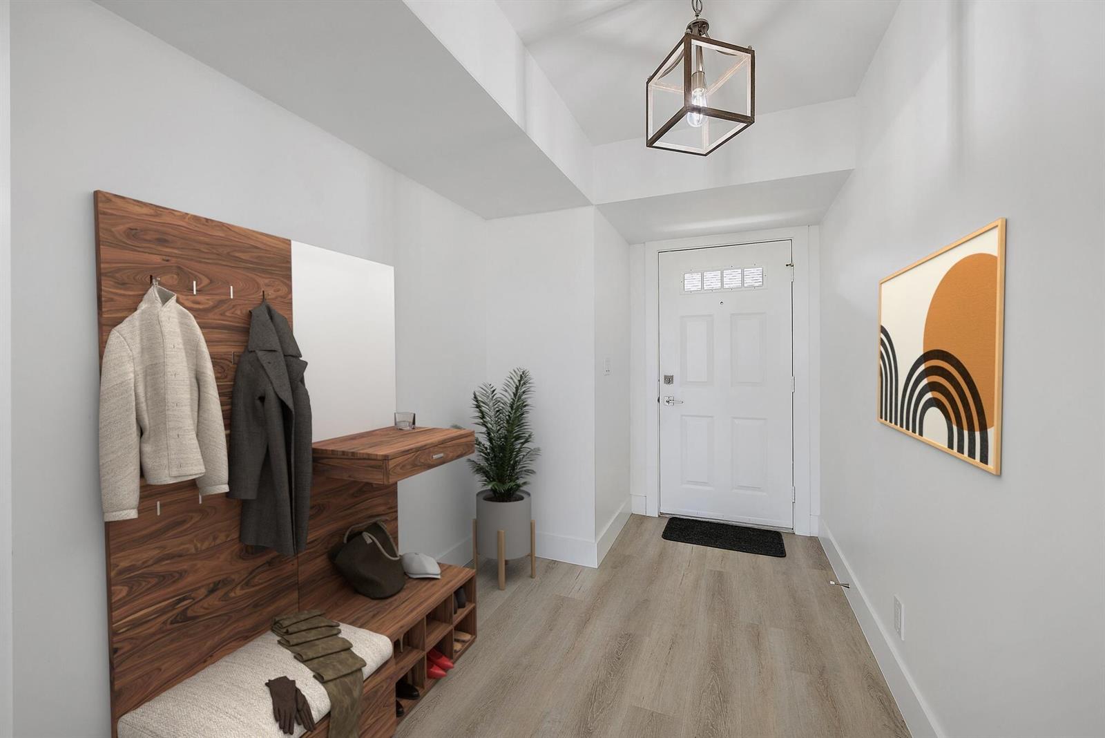 A modern entryway features wood-paneled coat storage, a bench, light flooring, and a white door — 10459 SE Terrapin Place # 101d, Jupiter FL 33469, JUPITER, FL