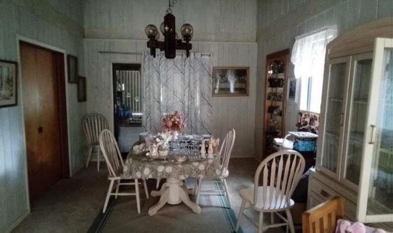 A dining room features a round table with chairs, a chandelier, and a wooden hutch — 596 Greenwood Drive, Jupiter FL 33458, JUPITER, FL