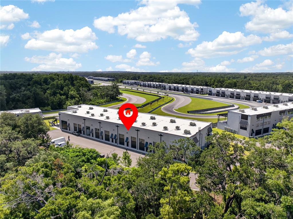 An aerial view shows a commercial warehouse building with a red location pin — 6500 MOTOR ENCLAVE WAY UNIT 1514, TAMPA, FL