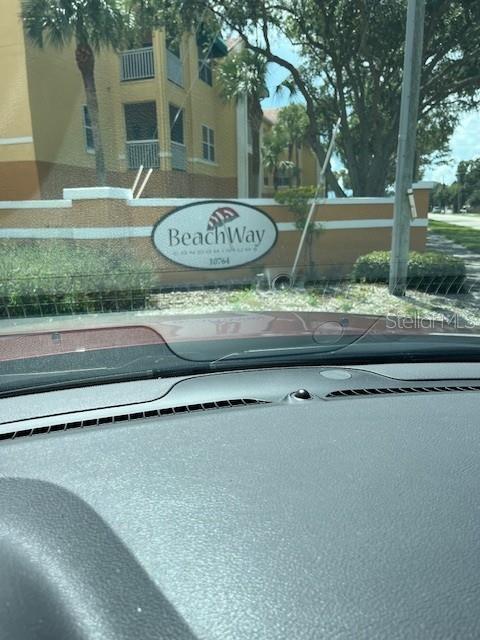 A view from inside a vehicle shows the exterior sign for BeachWay Condominiums — 10764 70TH AVENUE UNIT 1106, SEMINOLE, FL