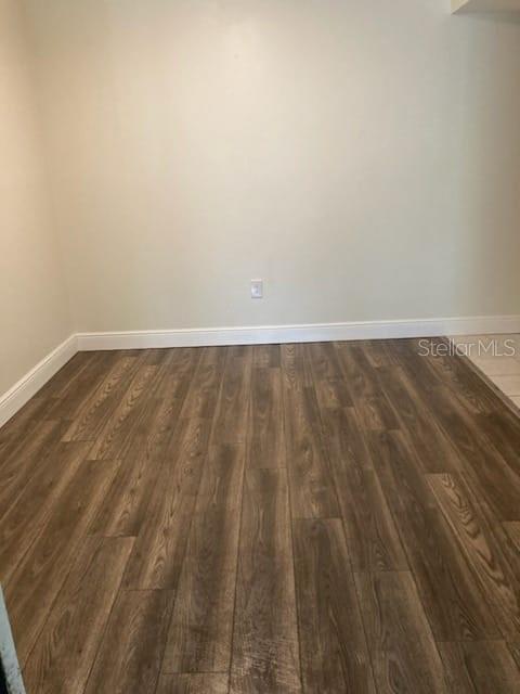 An empty room features light-colored walls, white baseboards, and wood-look laminate flooring — 914 LAKE DESTINY ROAD UNIT H, ALTAMONTE SPRINGS, FL