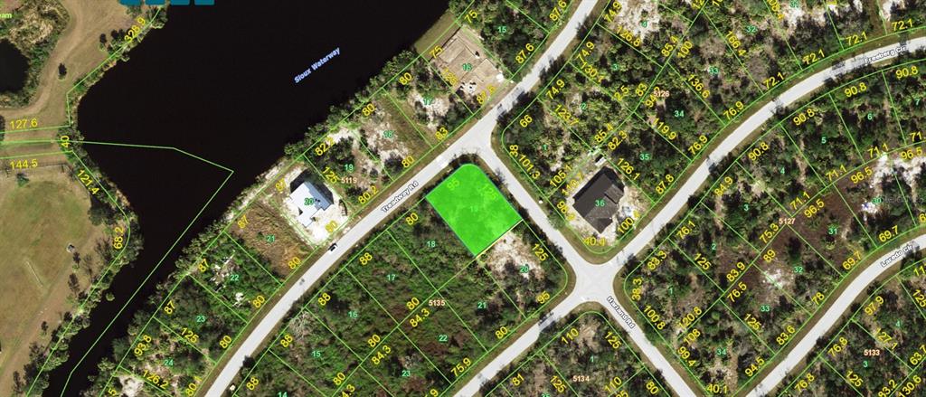 This is an aerial map showing a vacant, highlighted residential lot situated between two roads — 7044 TREADWAY ROAD, PORT CHARLOTTE, FL