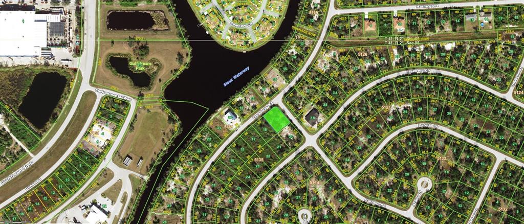 This is an aerial map showing a vacant lot highlighted in green within a residential neighborhood — 7044 TREADWAY ROAD, PORT CHARLOTTE, FL