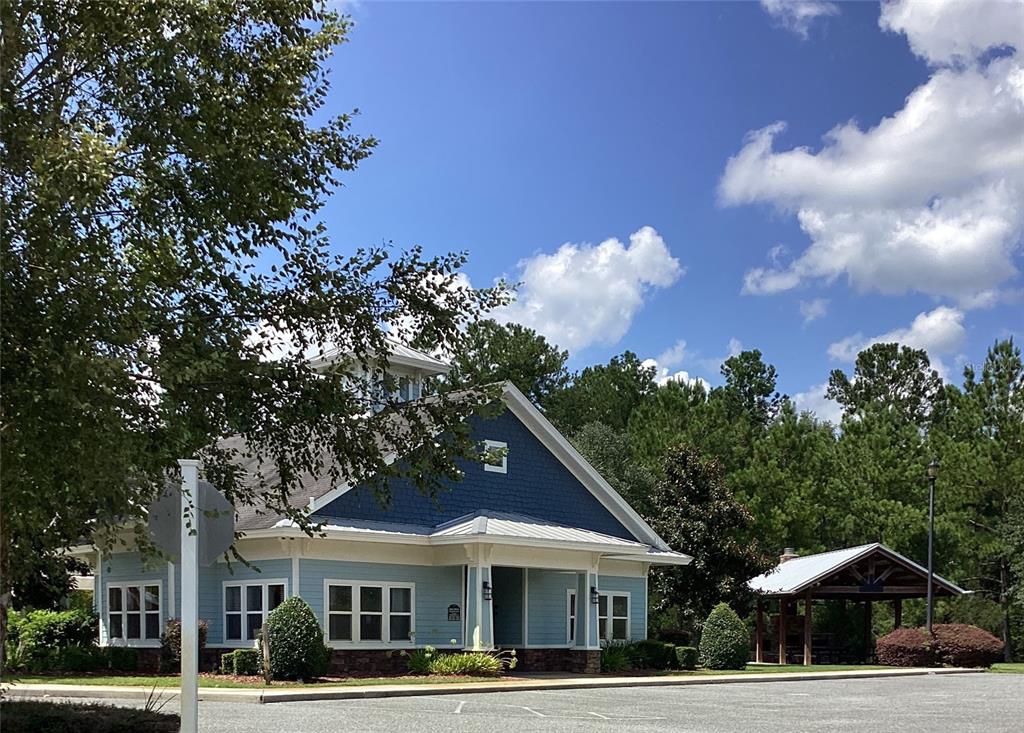 A light blue building with a dark blue gable and an adjacent wooden pavilion — 149 SW BELLFLOWER DRIVE, LAKE CITY, FL