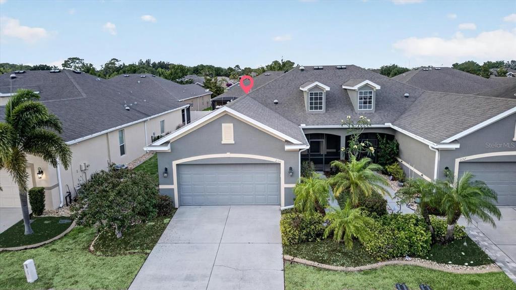An exterior view of a gray suburban house with a garage and a tiled roof — 2153 BARRACUDA COURT, HOLIDAY, FL