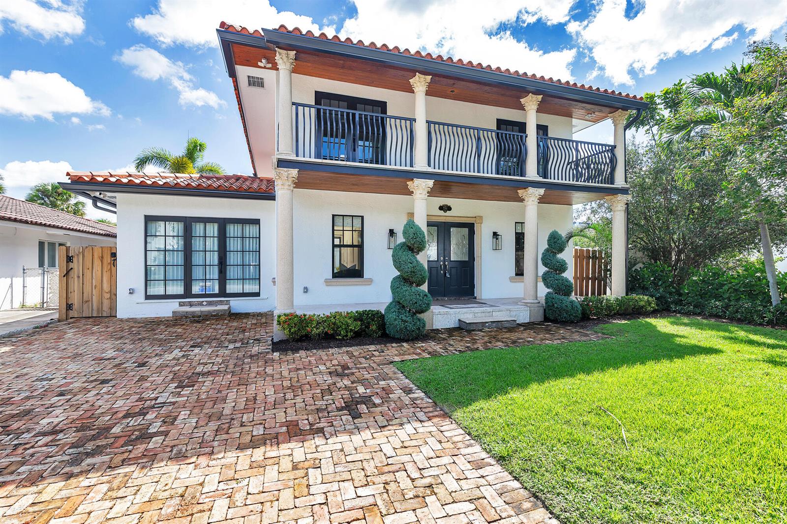 A two-story house with a brick driveway, white stucco walls, and a second-floor balcony — 254 9th Street, West Palm Beach FL 33401, WEST PALM BEACH, FL