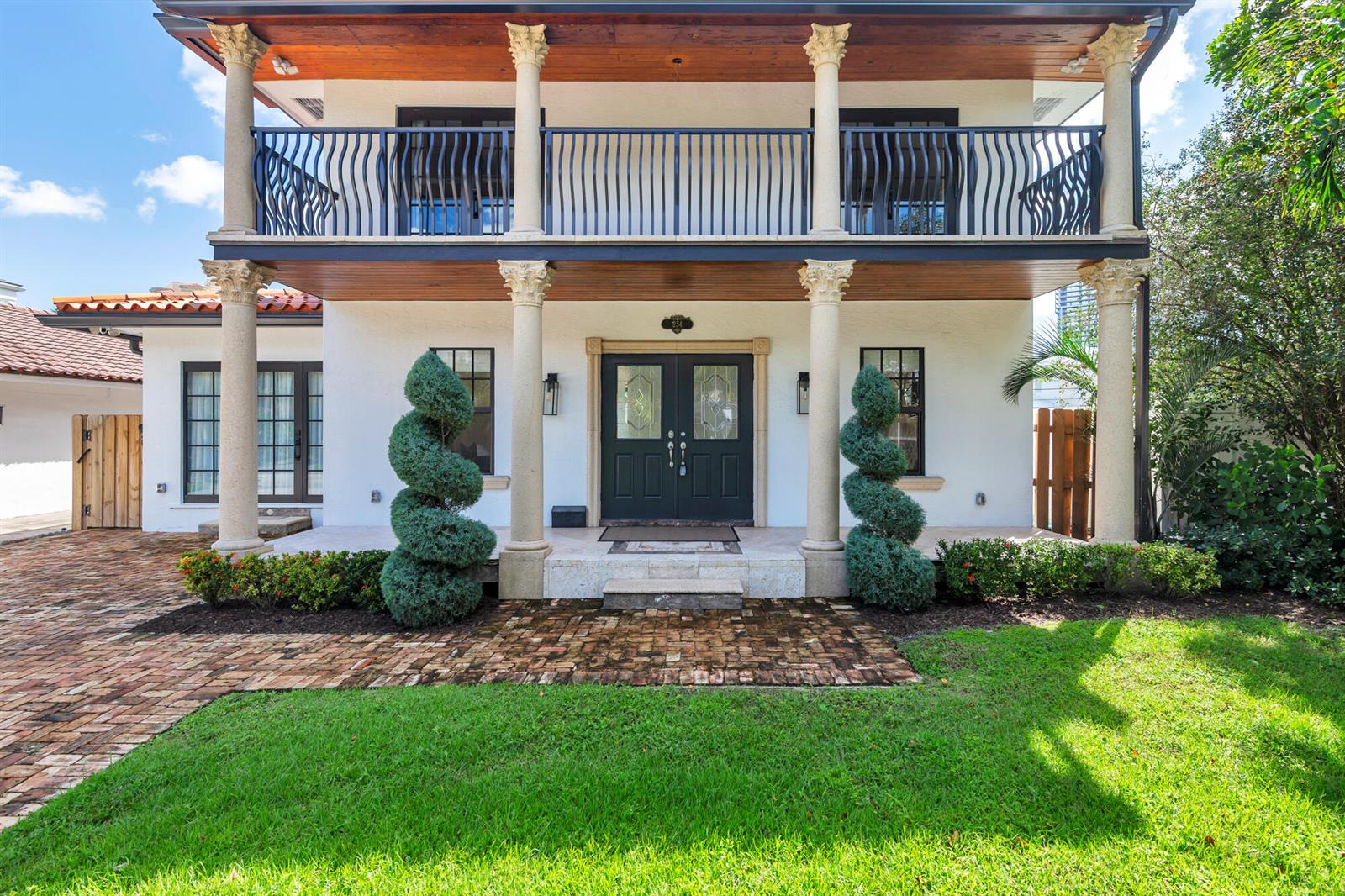 A two-story house features a white stucco facade, a wooden balcony, and four decorative columns — 254 9th Street, West Palm Beach FL 33401, WEST PALM BEACH, FL