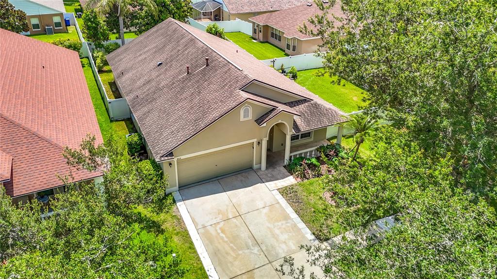 An aerial view of a single-story suburban house with a tan exterior and brown roof — 805 LESA GLEN PLACE, BRANDON, FL