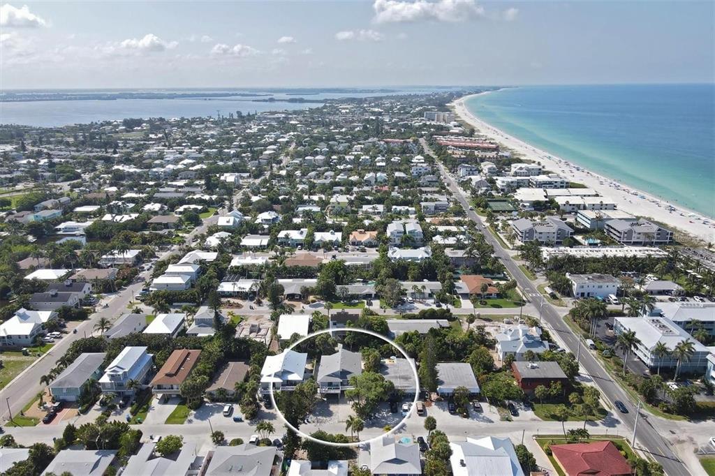 An aerial view of a coastal neighborhood with a white circle highlighting a specific house — 207 71ST STREET UNIT E, HOLMES BEACH, FL