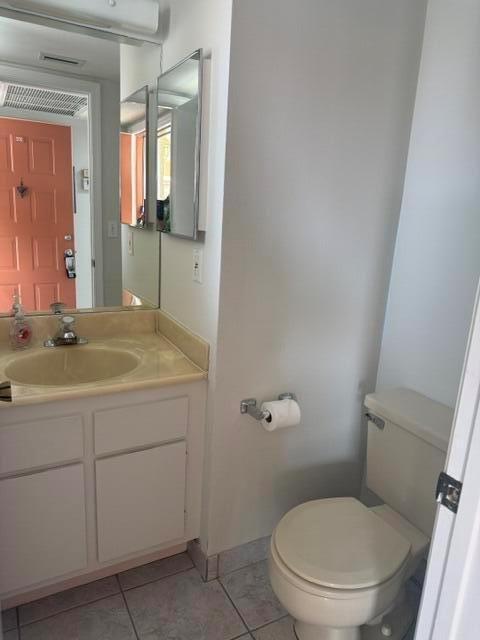A bathroom features a vanity with a sink, a mirror, and a toilet — 3031 Holiday Springs Boulevard # 7, Margate FL 33063, MARGATE, FL