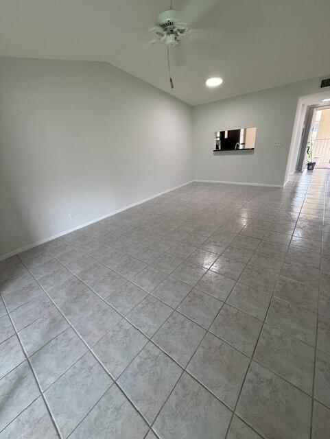 An empty room with light gray walls, tile flooring, and a ceiling fan — 3031 Holiday Springs Boulevard # 7, Margate FL 33063, MARGATE, FL