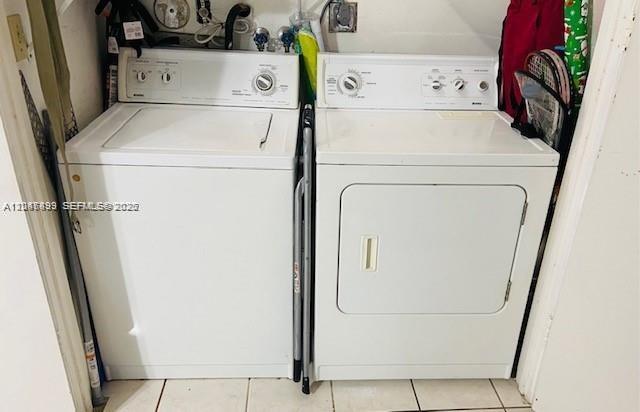 A white top-loading washing machine and a white dryer sit side-by-side in a laundry closet — 8075 NW 8th St # 6, Miami FL 33126, MIAMI, FL