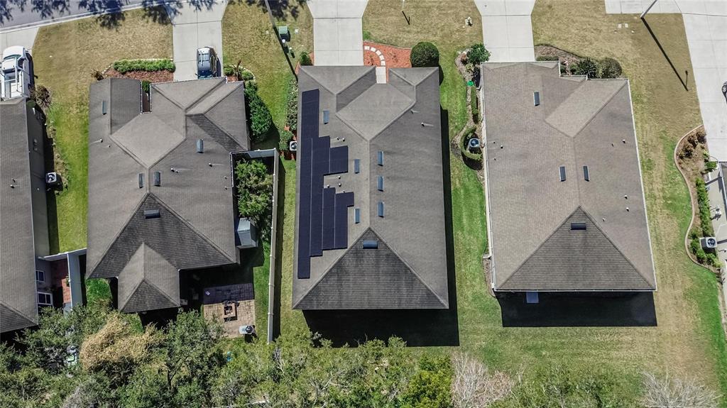 An aerial view shows three suburban houses with shingled roofs, one featuring a solar panel array — 2819 HOLLY BLUFF COURT, PLANT CITY, FL