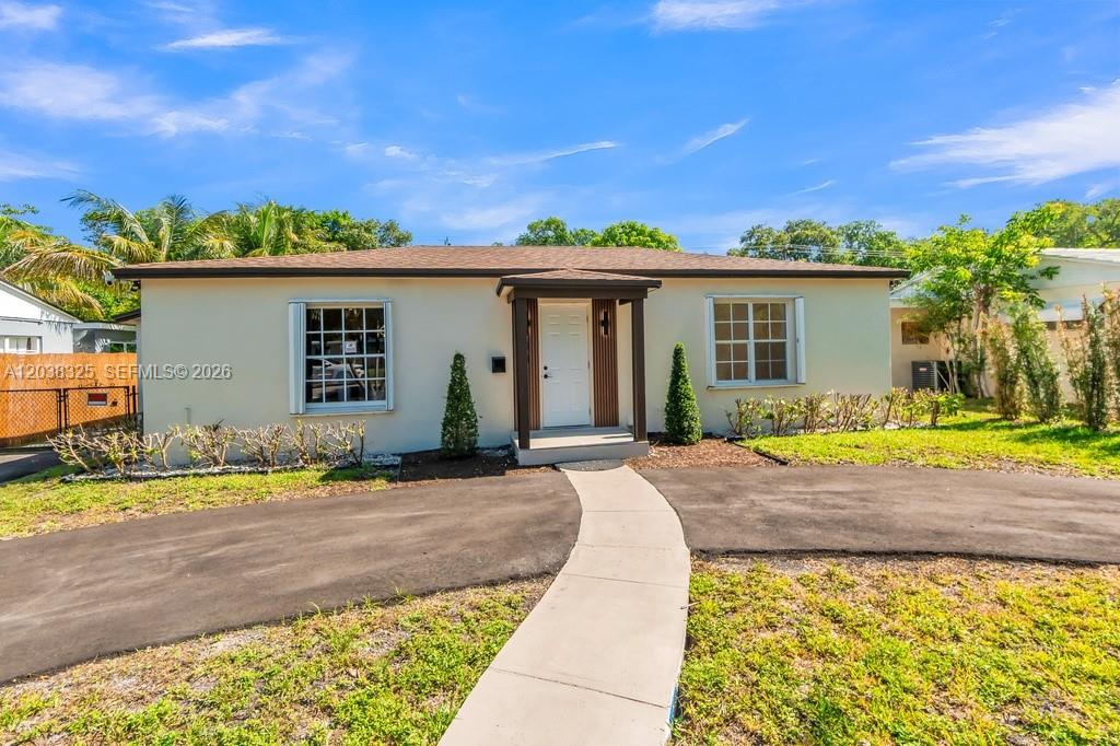 A single-story house with a white exterior, a brown roof, and a paved walkway — 831 NE 128th St, North Miami FL 33161, NORTH MIAMI, FL