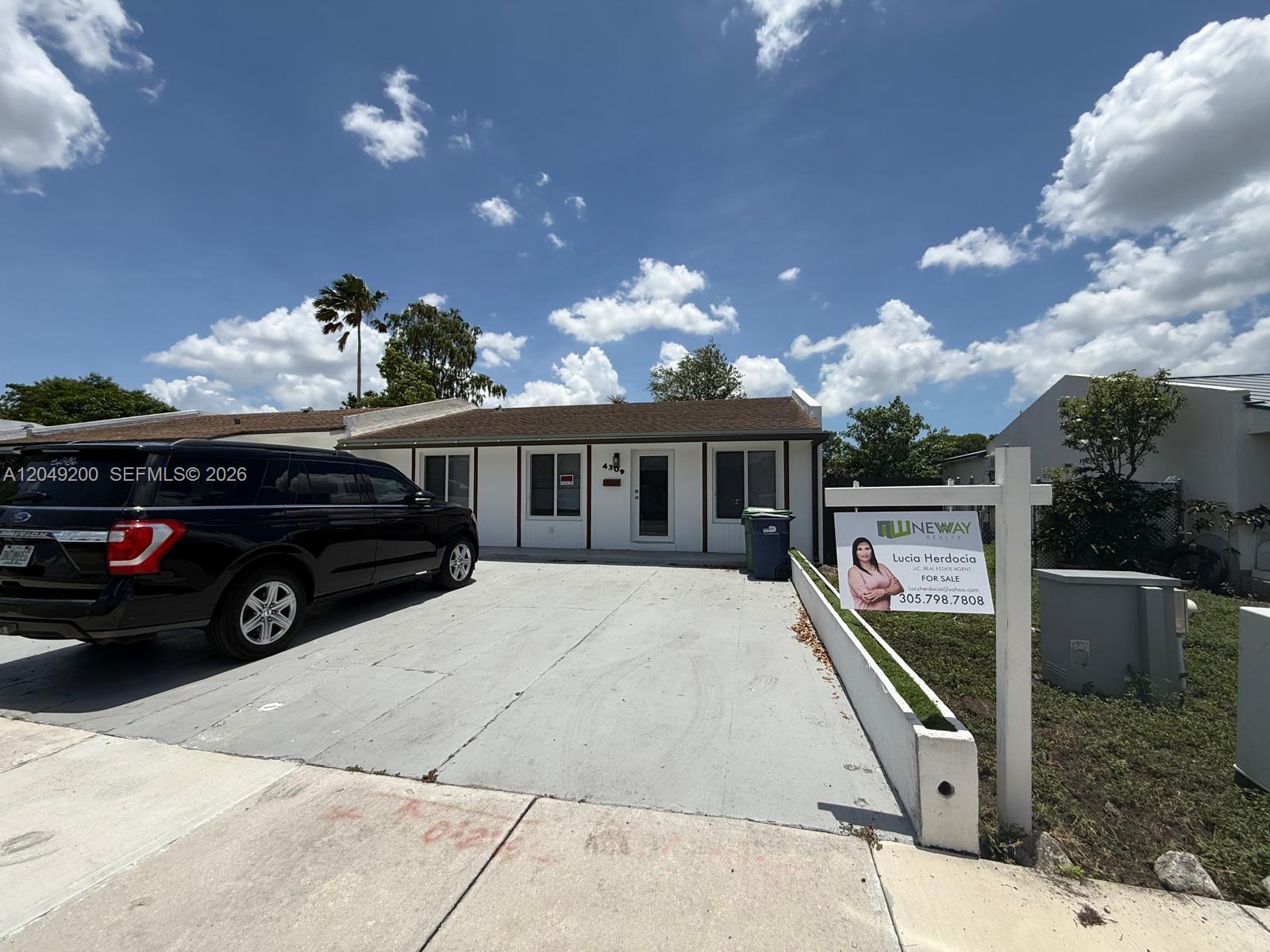 An empty room with light-colored tile flooring, a ceiling fan, and an attached bathroom — 4309 SW 129th Ave, Miami FL 33175, MIAMI, FL