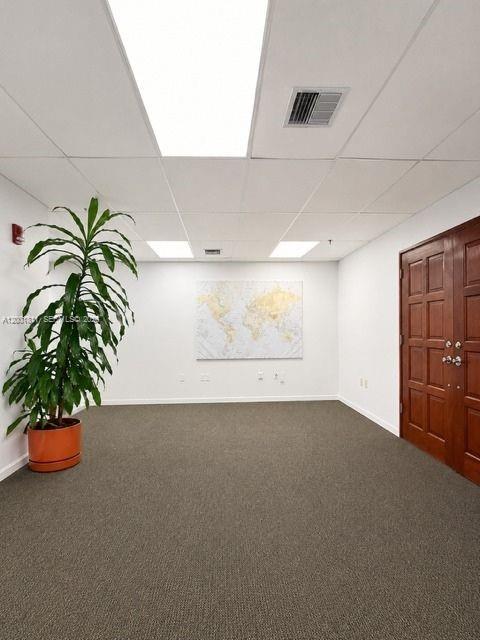 A room features gray carpeting, a drop ceiling, a potted plant, and double wooden doors — 2600 SW 3rd Ave # 750, Miami FL 33129, MIAMI, FL