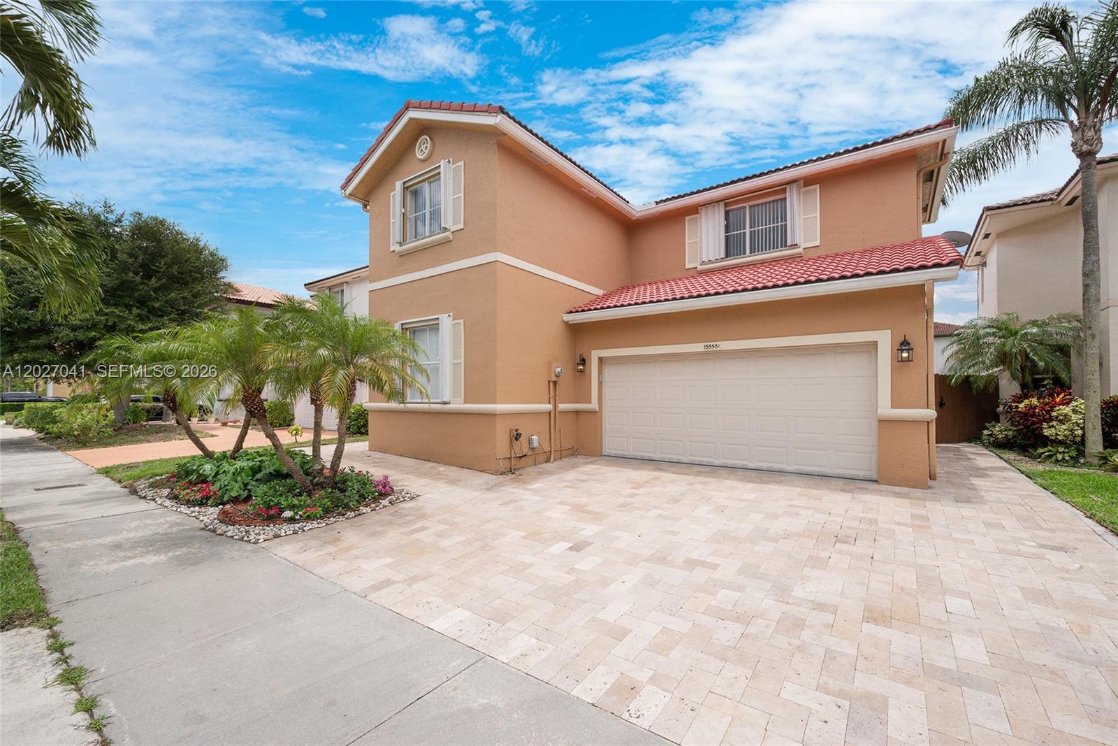 A two-story tan house with a red tile roof and a paved driveway — 15558 SW 112th Dr, Miami FL 33196, MIAMI, FL