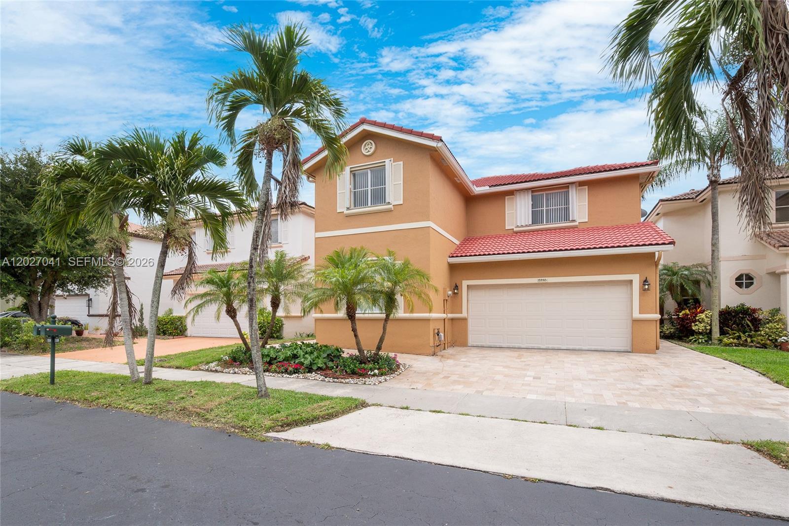 A two-story tan house with a red tile roof and a two-car garage — 15558 SW 112th Dr, Miami FL 33196, MIAMI, FL