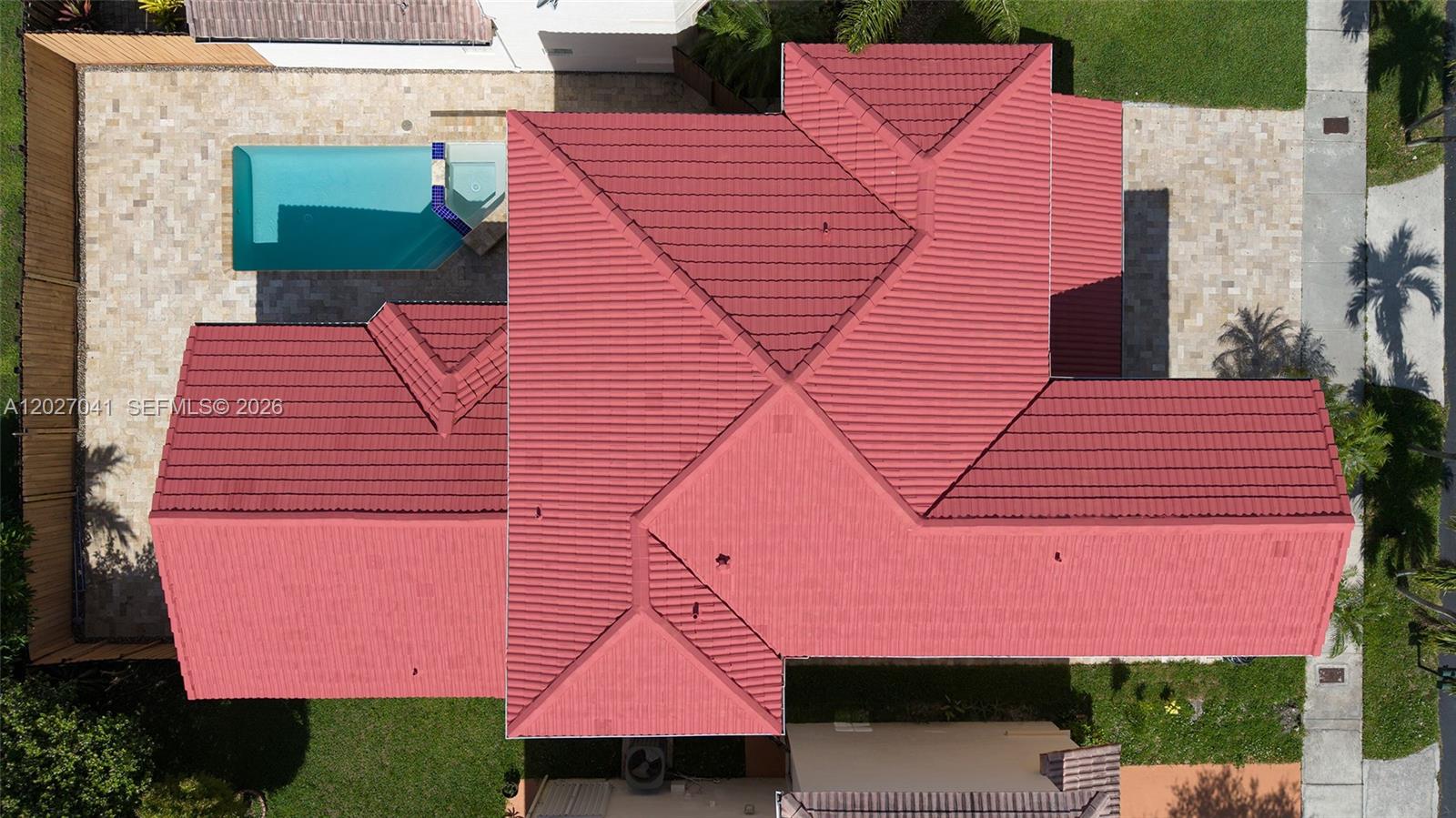 An aerial view shows the red tile roof of a house with a swimming pool — 15558 SW 112th Dr, Miami FL 33196, MIAMI, FL