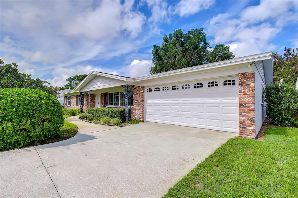 A single-story brick house with a white garage door and a concrete driveway — 2205 MALIBU DRIVE, BRANDON, FL