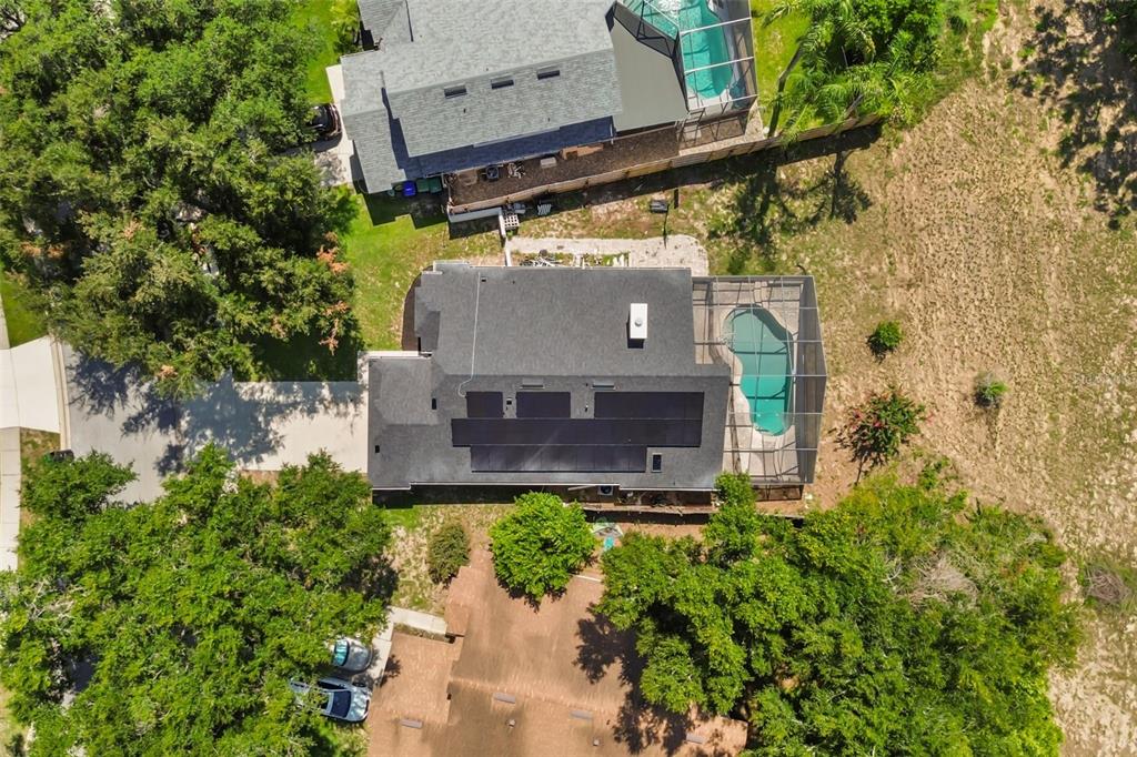 An aerial view shows a house with solar panels and a screened-in pool — 1032 NIN STREET, ORLANDO, FL