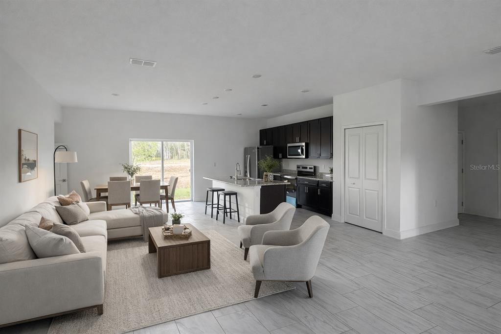 A single-story gray house with a white garage door and a concrete driveway — 2885 W REDGATE DRIVE, DUNNELLON, FL