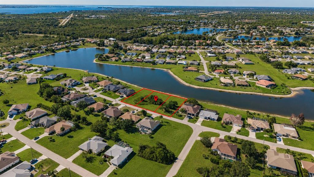 An aerial view shows three adjacent vacant lots outlined in red along a waterfront — 2361 SOFIA LANE, PUNTA GORDA, FL