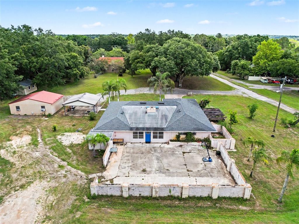 An aerial view of a single-story house with a brick driveway and two palm trees — 10073 LAKE MEADOW ROAD, APOPKA, FL