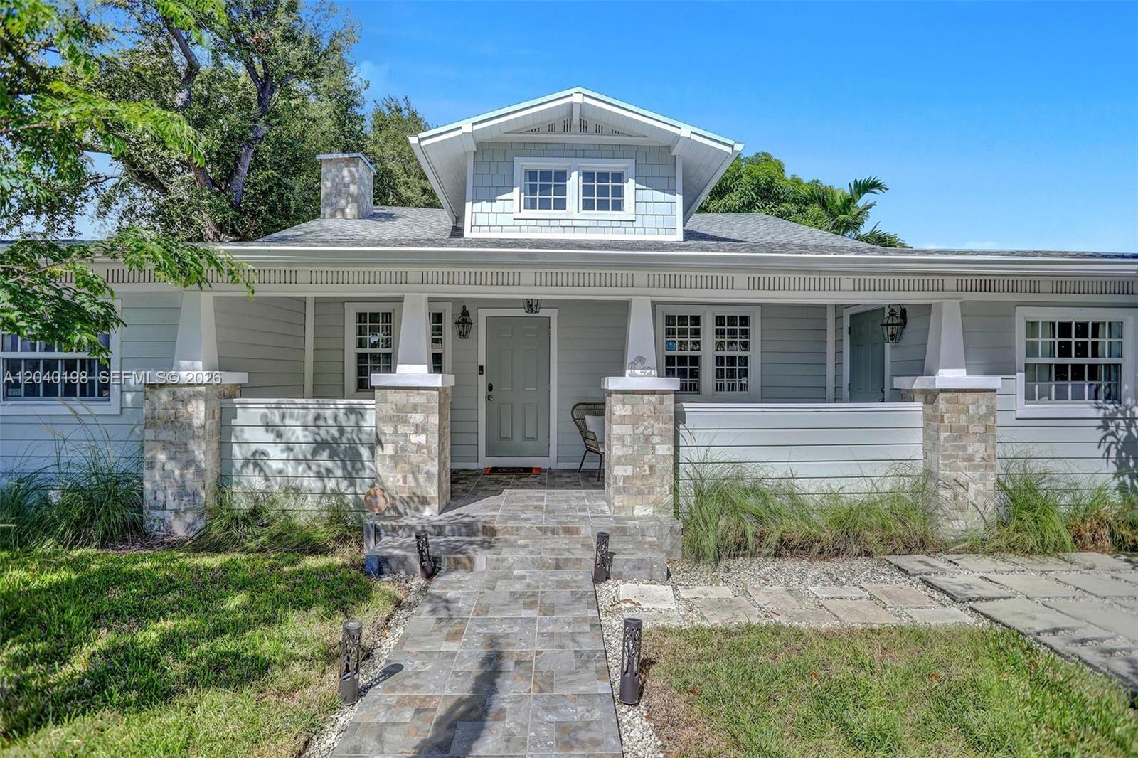 A light blue house with a stone-accented front porch and a tiled walkway — 421 NE 70th ST, Miami FL 33138, MIAMI, FL