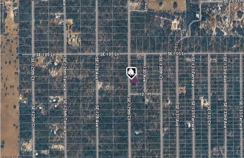 This is an aerial map showing a highlighted parcel of land surrounded by wooded lots — LOT 14 SE 129TH COURT, DUNNELLON, FL