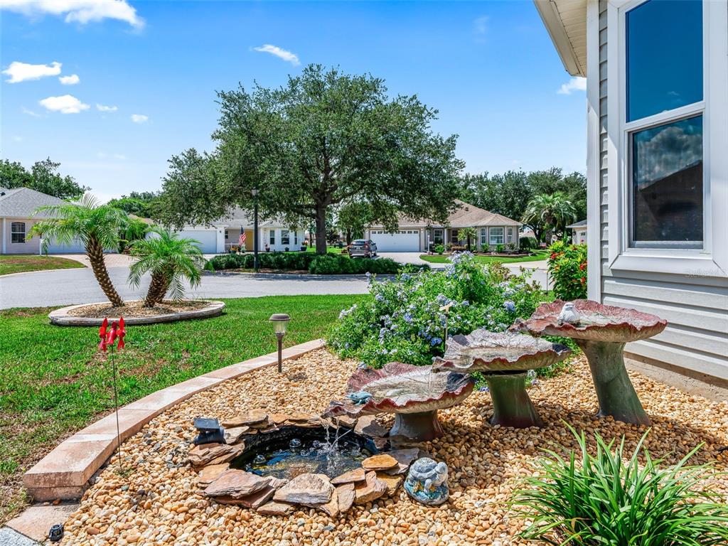 An aerial view shows a house with a gray roof, screened-in patio, and landscaped yard — 17946 SE 87TH MELROSE COURT, THE VILLAGES, FL