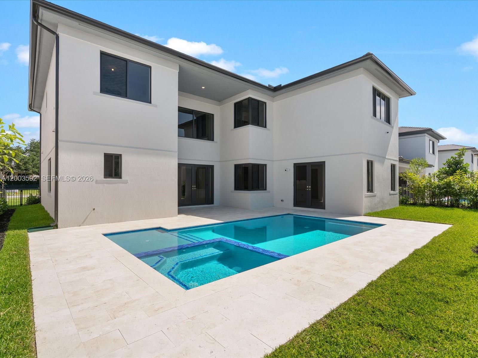 A two-story white house features a backyard swimming pool with an integrated spa — 19602 NE 14 CT # 0, Miami FL 33179, MIAMI, FL