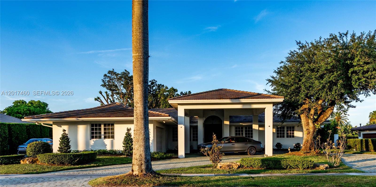 A single-story house with a large covered entryway and a paved driveway — 15761 Turnberry Dr, Miami Lakes FL 33014, MIAMI LAKES, FL