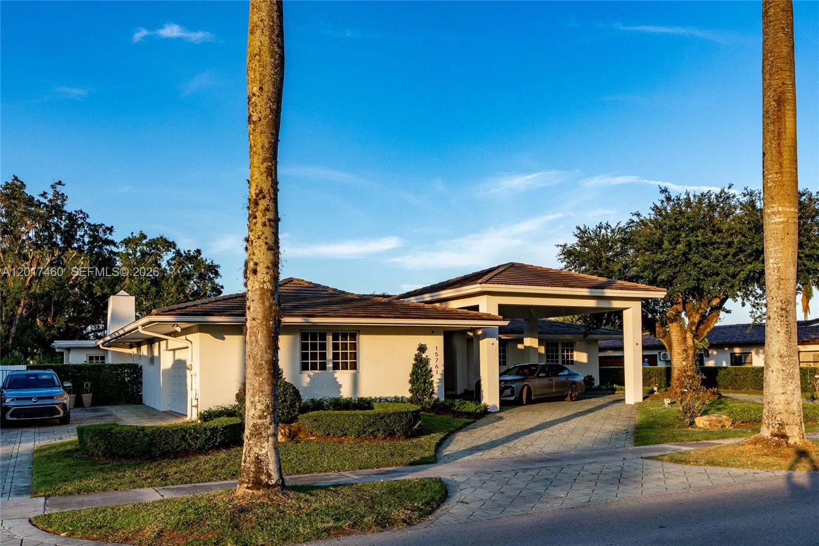 A single-story house with a paved driveway, a carport, and two tall palm trees — 15761 Turnberry Dr, Miami Lakes FL 33014, MIAMI LAKES, FL