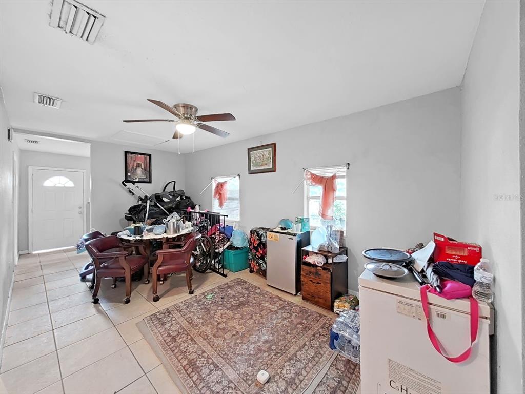 A room with tile flooring, a ceiling fan, and a dining area with chairs — 1514 E NORTH BAY STREET, TAMPA, FL