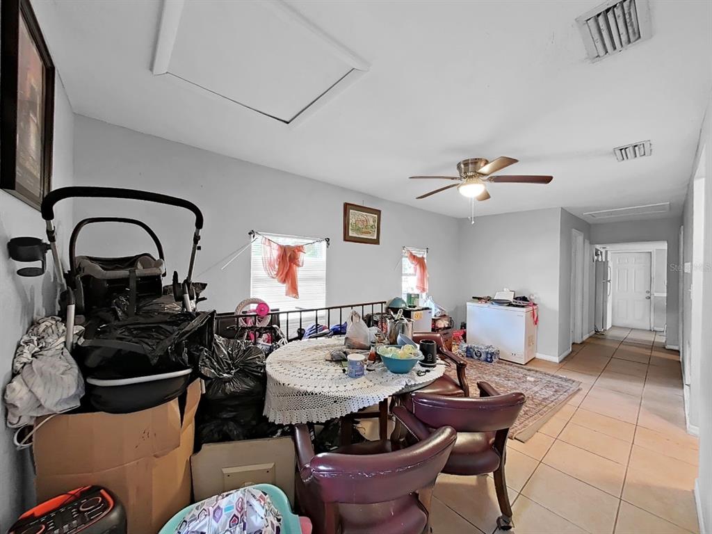 A dining area with tile flooring, a round table, and a ceiling fan — 1514 E NORTH BAY STREET, TAMPA, FL