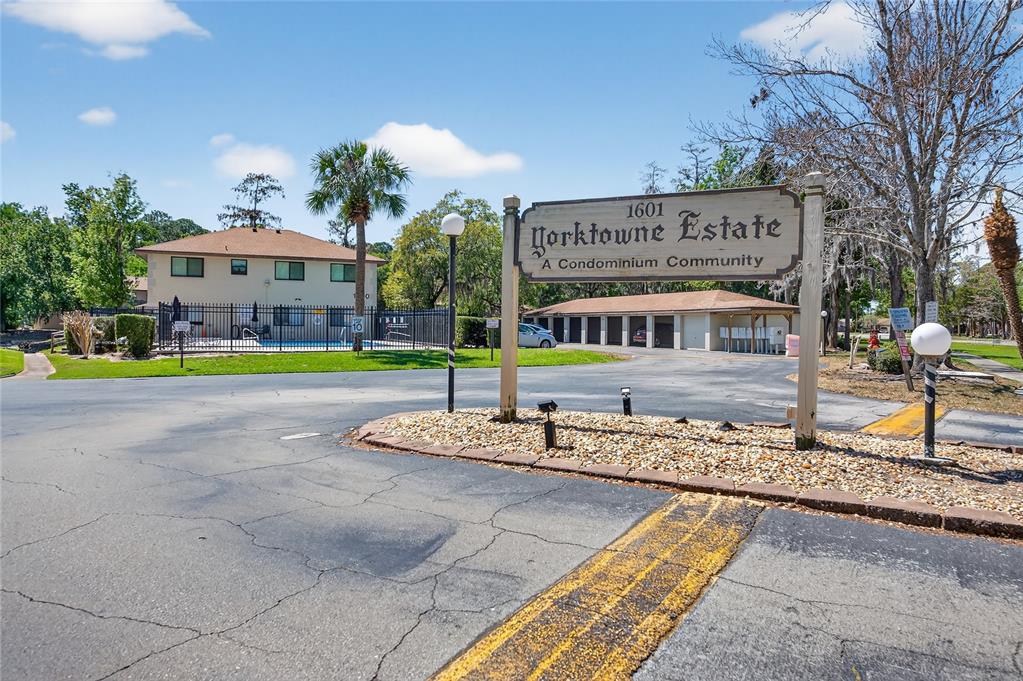 A sign for Yorktowne Estate stands at the entrance to a community with a pool — 1601 BIG TREE ROAD UNIT 101, SOUTH DAYTONA, FL