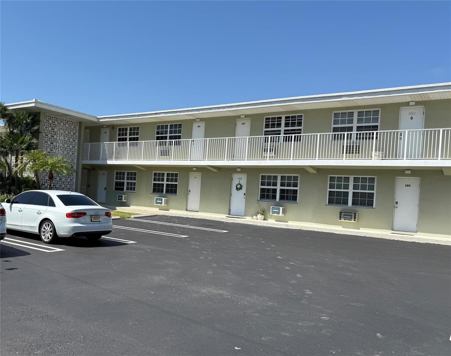 A two-story apartment building with a white balcony, light green exterior, and a parking lot — 1105 S Riverside Drive # 205, Pompano Beach FL 33062, POMPANO BEACH, FL