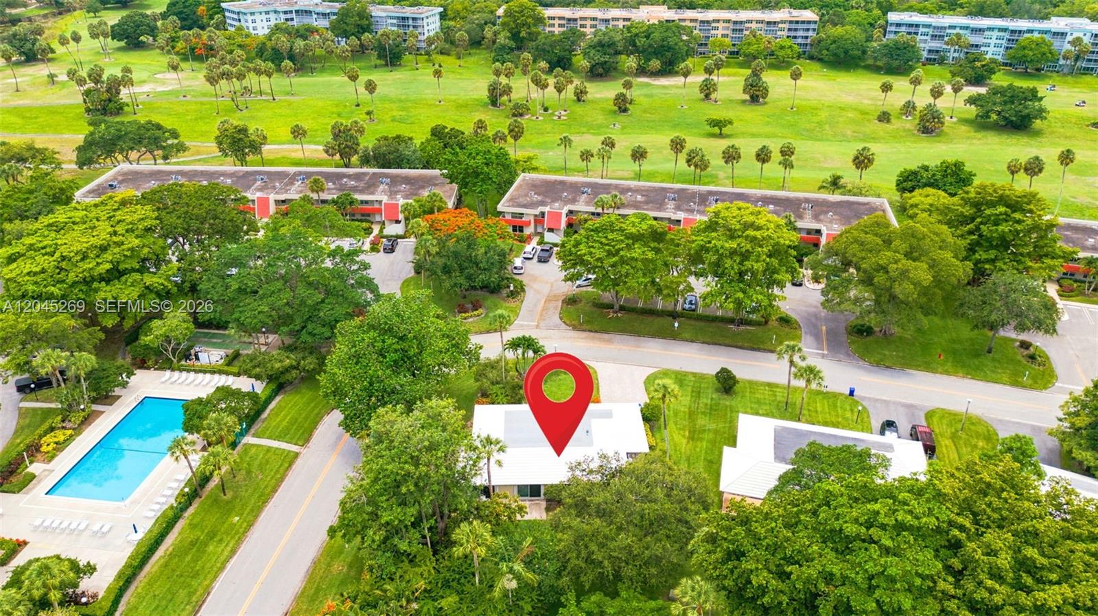 An aerial view shows a house with a red location pin, a pool, and surrounding greenery — 908 Cypress Ter # V57, Pompano Beach FL 33069, POMPANO BEACH, FL
