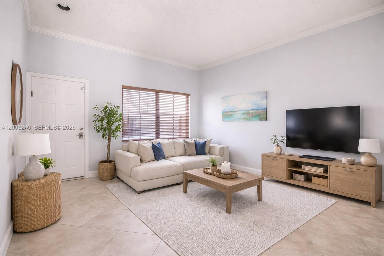 A living room features a beige sectional sofa, a wooden coffee table, and a television console — 777 Tanglewood Cir, Weston FL 33327, WESTON, FL