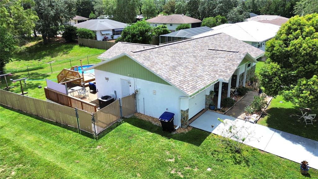 An aerial view shows a single-story house with a shingled roof, driveway, and backyard pool — 3103 N WOOLFLOWER TERRACE, BEVERLY HILLS, FL
