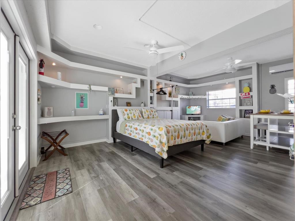 A laundry room with bright blue walls, a white washer and dryer, and octopus shower curtain — 3801 1ST AVENUE S, ST PETERSBURG, FL
