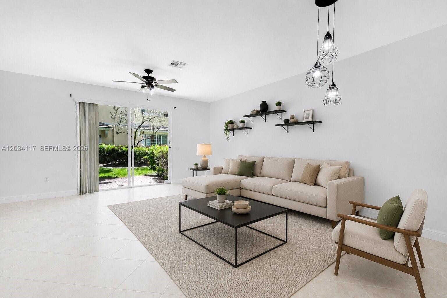 A living room features a beige sectional sofa, a coffee table, and sliding glass doors — 7782 Paddock Pl, Davie FL 33328, DAVIE, FL