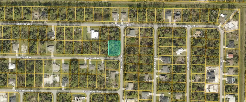 This is an aerial map showing a highlighted vacant residential lot at a street intersection — LANDRY AVENUE, NORTH PORT, FL