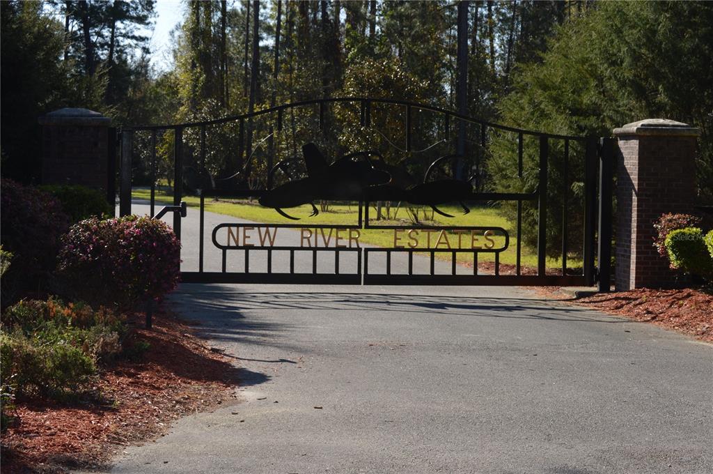 A black metal gate with the words New River Estates marks the entrance to a property — Parcel 1 CR-18A, WORTHINGTON SPRINGS, FL