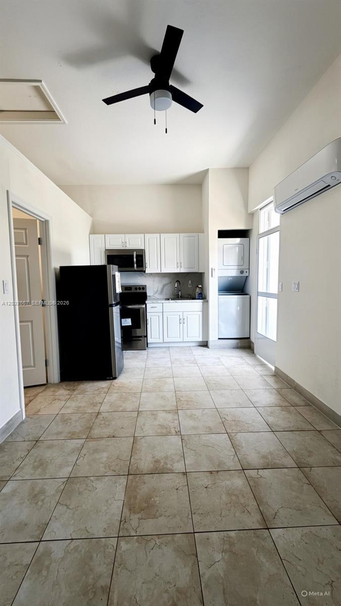 A kitchen with white cabinets, stainless steel appliances, and tile flooring — 18405 SW 132nd Ave # 18405, Miami FL 33177, MIAMI, FL
